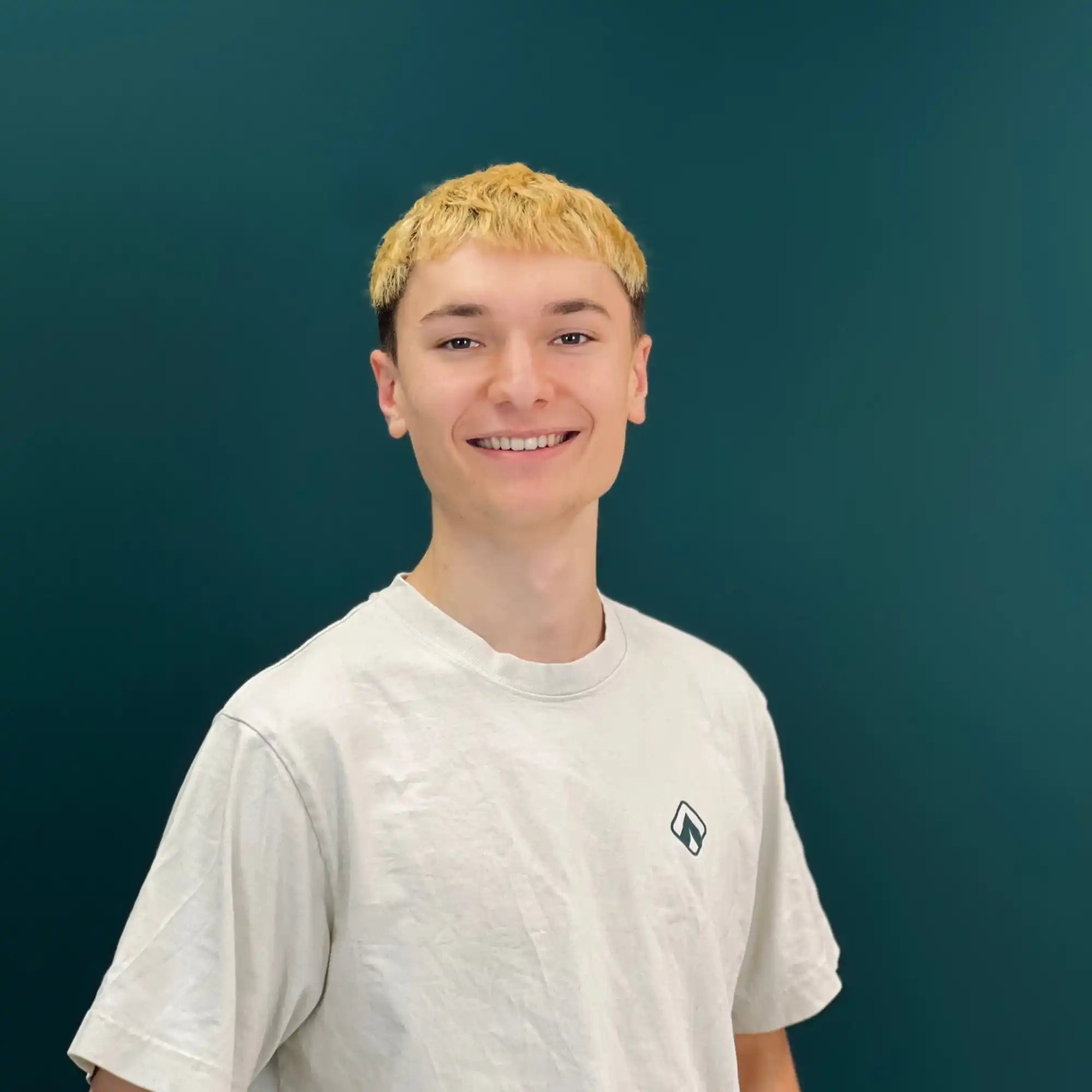 Lächelnder junger Mann mit blonden Haaren.