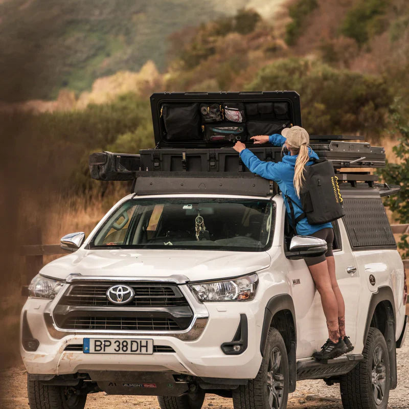 Weißer toyota hilux mit schwarzer horntools transportbox wasserdicht 98 liter dachbox offroad auf dem dach